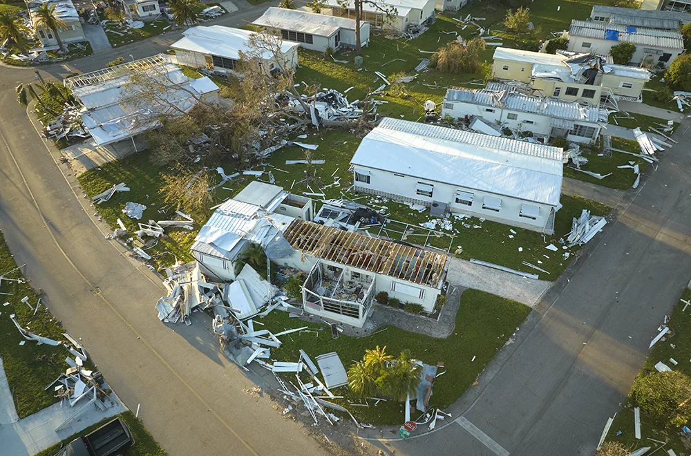 a lot of houses damaged due to a tornado with house roofs blown off