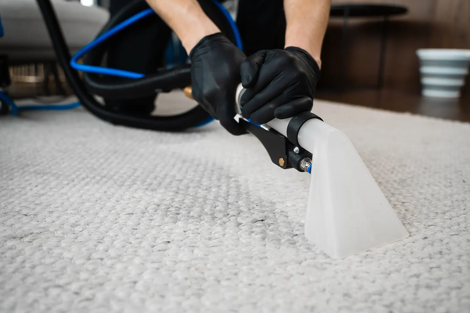 a worker cleaning a carpet