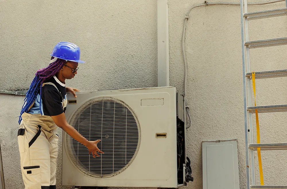 hvac-cleaning a worker checking an HVAC unit