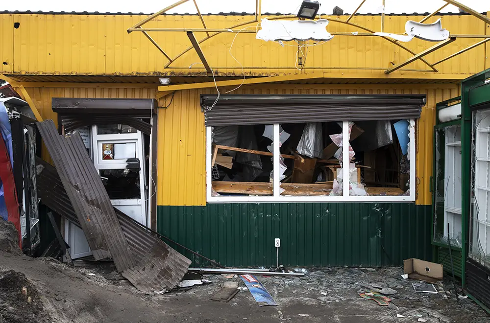 residential-wind-damage a store front damaged after a storm