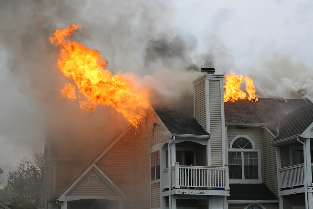 a flame erupting from a house