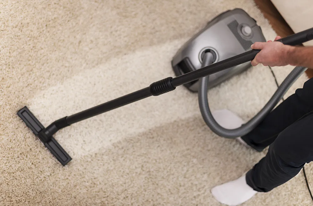 cleaning-dirty-carpet a vacuum cleaner being used to clean a carpet