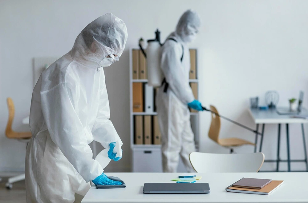 2 workers cleaning a room