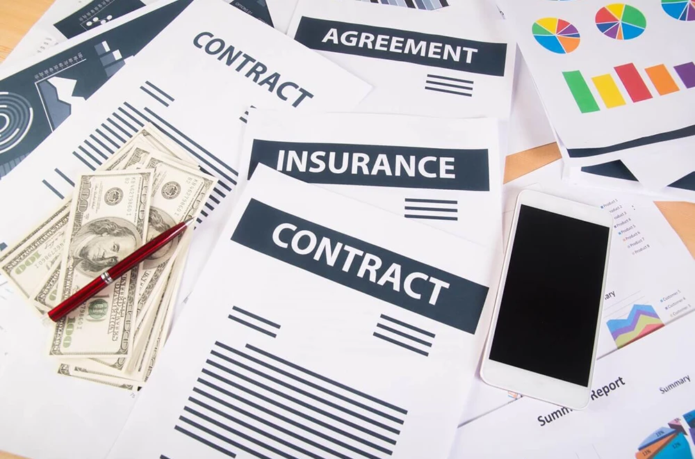 contracts a pile of papers with contract and insurance contract in them