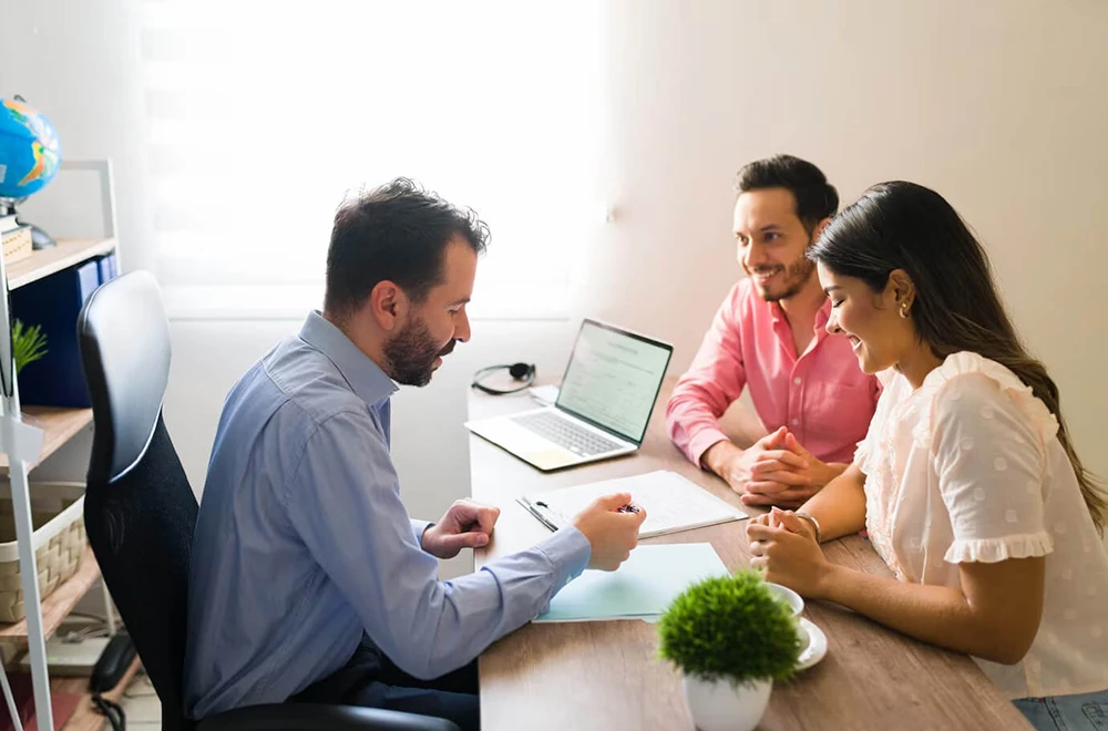 insurance agent helping a couple with their claim