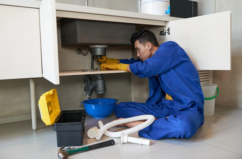 plumber fixing a sink