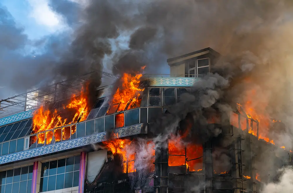 a fire bursting out of a building