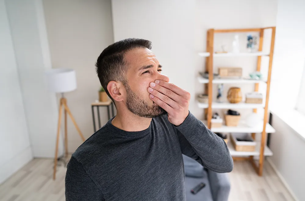 man-getting-hindered-by-a-smell man squeezing his nose