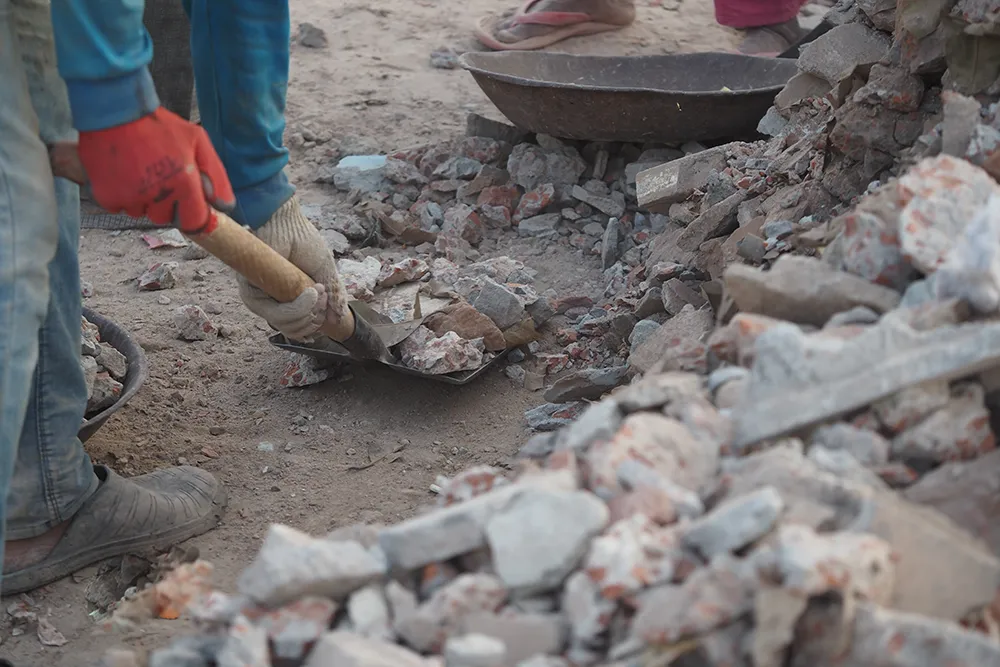 person cleaning debris